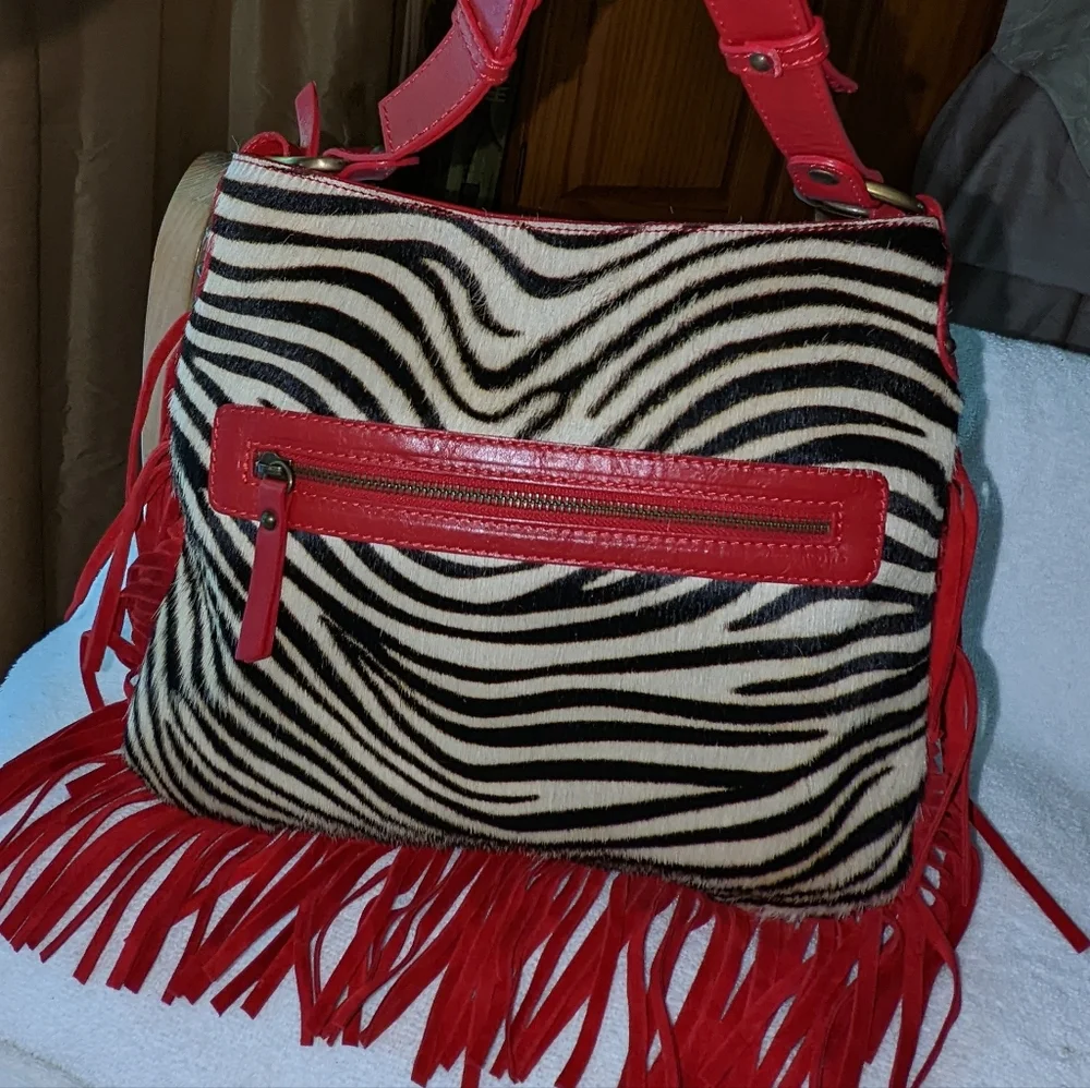 Innue Italy zebra print red leather crossbody bag with fringes.